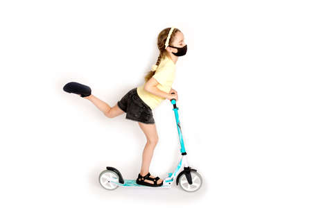 A teenage girl in a protective black Kovid-19 mask is actively involved in sports The concept of life during an epidemicの写真素材