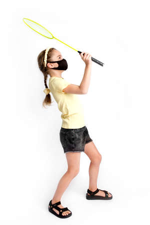 A teenage girl in a protective black Kovid-19 mask is actively involved in sports The concept of life during an epidemicの写真素材