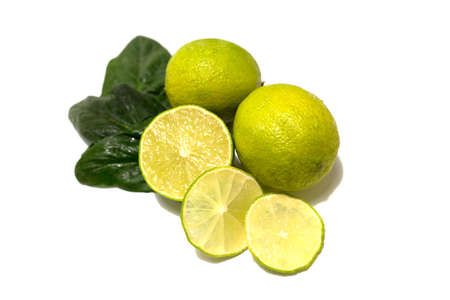 Fresh lime fruit. Whole fruits and cut. Lime leaves. Studio photography on a white background.の写真素材