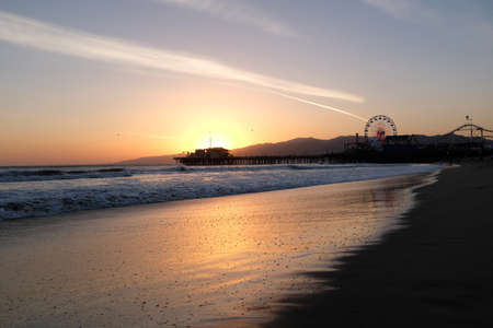 Sunset at Santa Monica Beach, California. The golden color of the sand.の写真素材