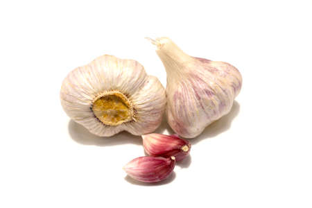Two heads of garlic and two cloves of garlic. Isolated on white background.の写真素材