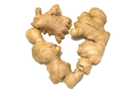Fresh ginger rhizome. Ginger is laid out in the shape of a heart. Isolated on white background.の写真素材