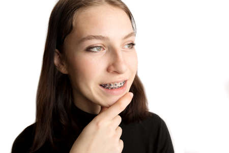 Orthodontic treatment. Dental care concept. Smiling teenage girl with braces. Metal braces close-up on the teeth.の写真素材