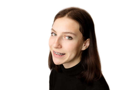 Orthodontic treatment. Dental care concept. Smiling teenage girl with braces. Metal braces close-up on the teeth.の写真素材