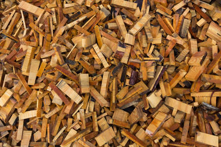 Texture. Woodworking waste. Heaps of chips, bark, pieces and sawdust.