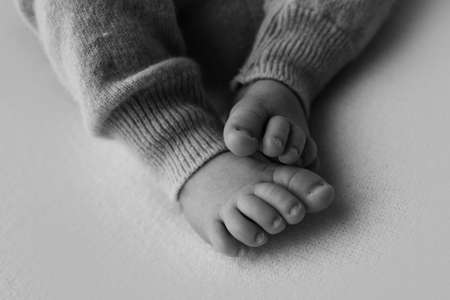 Newborn baby feet closeup. Pregnancy, motherhood, preparation and expectation of motherhood, the...