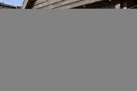 Pots for a rustic wood stove, dry on a rustic wooden palisade. Against the background of an old...