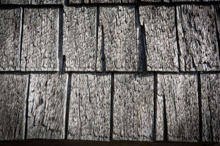Wooden logs of an old house. Close-up. Weathered natural gray wood texture. Background. Horizontal photo. High quality photoの写真素材
