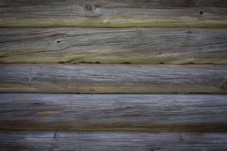 Wooden logs of an old house. Close-up. Weathered natural gray wood texture. Background. Horizontal photoの写真素材