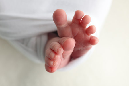 Foot of a newborn. Close up feet, toes, heels, feet of a newborn baby.の写真素材