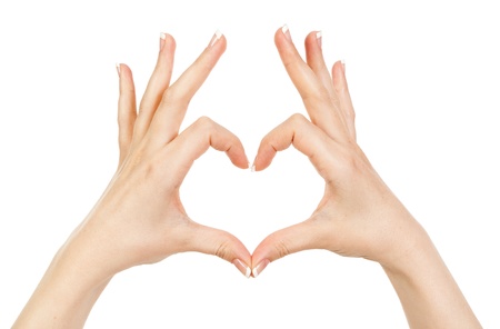 woman showing hands heart on a white backgroundの写真素材