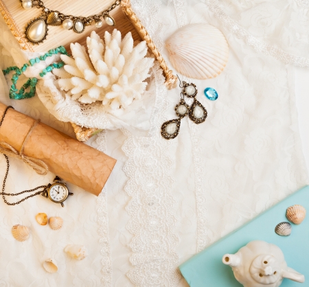 Vintage background with seashells, paper scroll, watch and jewelry. Romantic photoの写真素材