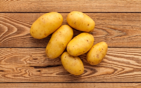 Potatos on a wooden backgroundの写真素材