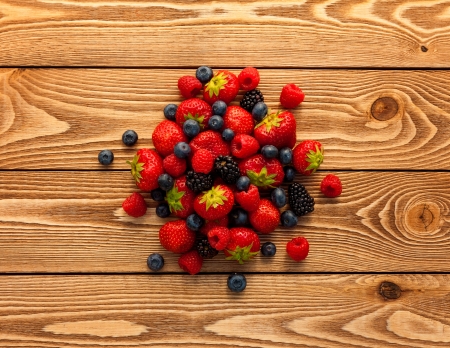 Berries on Wooden Background.