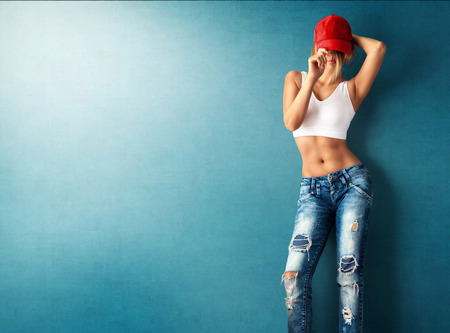 Sexy young woman in a trendy clothes on a grunge backgroundの写真素材