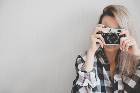 Soft photo of woman in checkered shirt making a pictureの写真素材