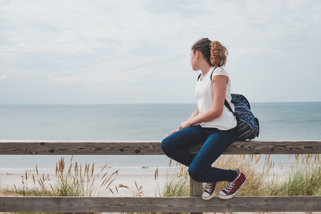 Young girl is sitting at the beachの写真素材