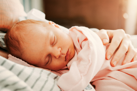 Cute little baby sleeping with mother. Happy Family concept.の写真素材