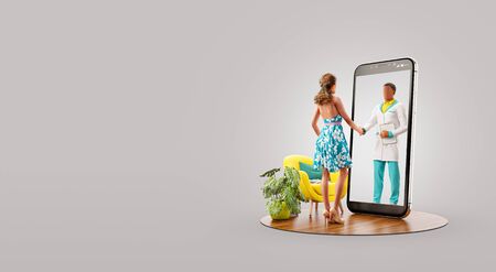 Woman standing in front of smartphone screen shaking hands with her doctor. Health care Smartphone apps. Online medical consultation and support concept. Unusual 3d illustrationの写真素材