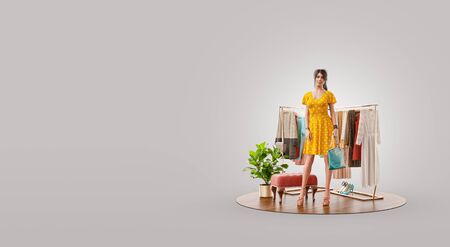 Beauty woman in casual clothes standing in boutique. Cloth market. Online shopping concept. Unusual 3d illustrationの写真素材