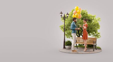Young beautiful couple in love on date. Young man with balloons and bouquet of flowers. Romantic relationship and family concept. Unusual 3d illustrationの写真素材