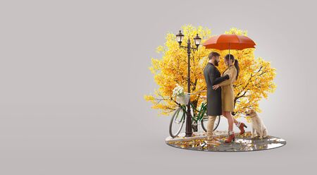 Young beautiful couple in love standing under umbrella and looking at each other on rainy autumn day. Romantic relationship and family concept. Valentines day. Unusual 3d illustrationの写真素材