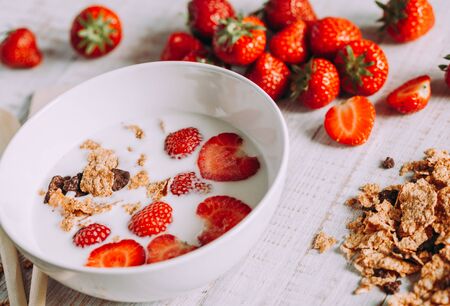 Strawberries in milk on a wooden table. Healthy breakfastの写真素材