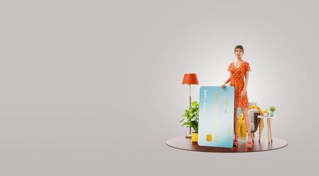 Unusual 3d illustration of a s female with credit card at her home.の写真素材