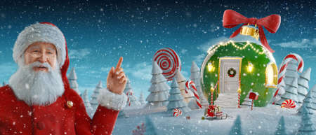 Santa Claus pointing at blank space. Amazing fairy house decorated at christmas in shape of christmas bauble. Unusual christmas 3d illustration. Merry Christmas and a Happy new year conceptの写真素材