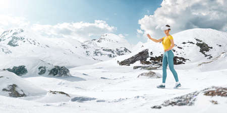 3d Illustration of a Female in Virtual Reality Headset Walking in Snowy Mountains at Sunny Day. Virtual Reality Traveling Concept. Unusual Design Concept.の写真素材