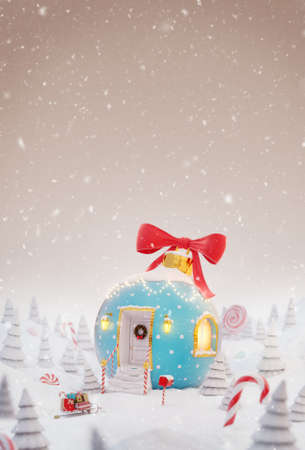 Unusual christmas 3d illustration greeting card. Cute cozy dreamlike house decorated at christmas in shape of christmas bauble with red ribbon and christmas lights in magical forest.の写真素材
