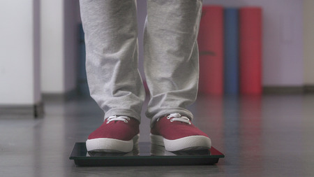 In the gym woman weighed after trainingの写真素材