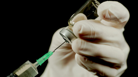 Doctor gains a medicine into a syringe.の写真素材