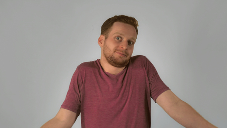 caucasian guy with red hair showing emotion surprise and misunderstanding. handsome redheaded men...