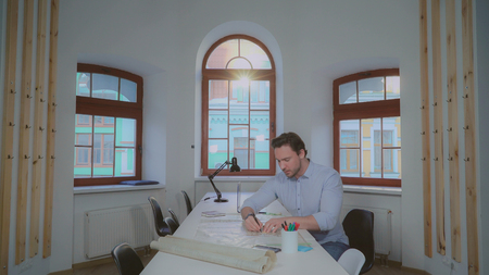 Two architect designers working in the office. Creative professional partners celebrating successful...