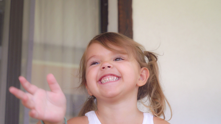 Happy kid smiling looking at he camera. Little cute girl four years ago have fun enjoy and showing positive emotions.の写真素材