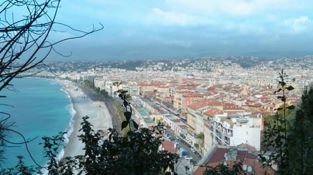 Landscape and azure sea with beach walking people riding cars on the road tourist town in spring season.time lapseの写真素材