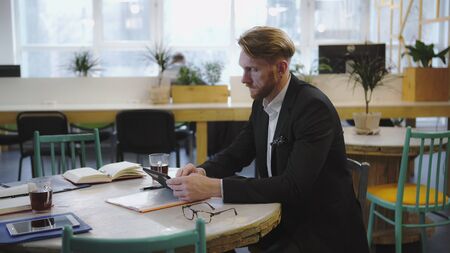 Businessman have coofee break and looks intently into the tablet