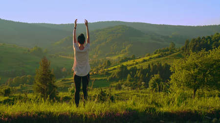 Woman is engaged in fitness in the mountains. High quality photo