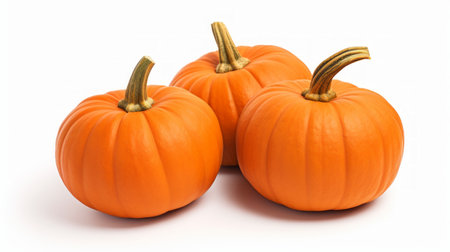 Close-up realistic photo featuring three bright orange pumpkins on a white background Generative AIの素材