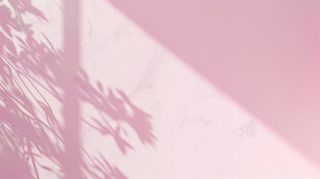 The image shows a pale pink wall illuminated by afternoon sunlight, casting delicate shadows of branches onto the surface. The shadows are soft and diffused, creating an ethereal and tranquil atmosphere.の素材