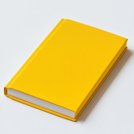 A bright yellow notepad with clean sheets is positioned on a light surface, inviting users to engage in creative writing or note-taking activities at any time.の素材