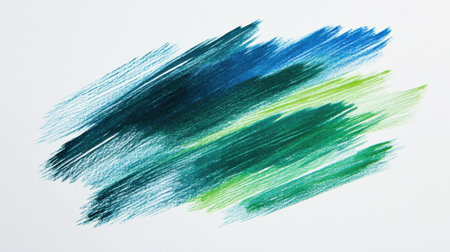Bright pencil strokes blend various shades of blue and green against a white background, showing an abstract design likely created in an artistic setting during the day.の素材