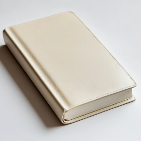 A soft leather notebook sits on a smooth, neutral surface. Its design is simple yet elegant, ideal for jotting down thoughts or sketches in a stylish manner.の素材