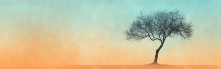 The scene features a minimalist silhouette of a single tree standing alone against a gradient sky that transitions from soft orange to blue. This tranquil setting evokes a sense of peace.の素材