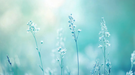 Delicate wildflowers stand tall amidst a soft haze of pale blue and teal, gently swaying in a calming morning breeze. The ethereal glow adds tranquility to the serene environment at dawn.の素材
