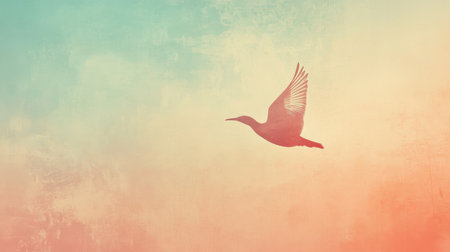 A graceful silhouette of a bird soars through a softly colored sky at twilight. The muted hues blend harmoniously, creating a serene atmosphere that captures the essence of freedom.の素材