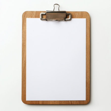 A polished wooden clipboard showcases a blank sheet, ideal for taking notes or listing tasks in a professional or educational setting during daylight hours.の素材