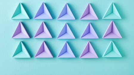 Colorful pastel mint and lavender triangles are arranged in a grid pattern on a smooth surface, creating a visually appealing minimalist design perfect for contemporary decor.の素材