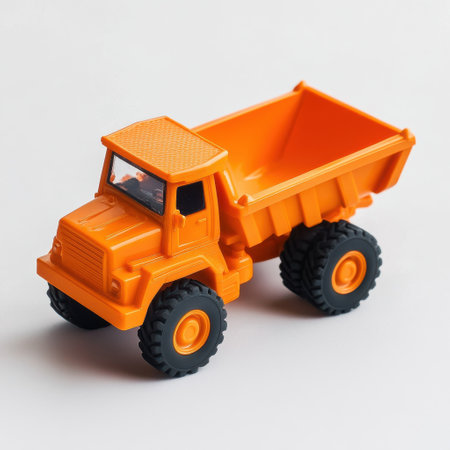 This vibrant toy dump truck is designed for endless fun, featuring a bright orange body and sturdy wheels. Perfect for children to engage in creative playtime, whether in the yard or indoors.の素材
